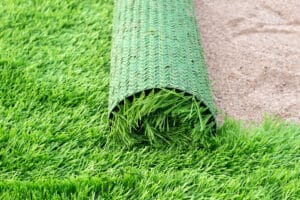 Lush green synthetic turf adorning the front yard of a contemporary residential house.