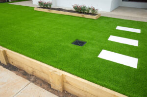 Lush green synthetic turf adorning the front yard of a contemporary residential house.