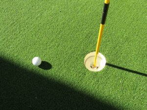 Putting green with a golf hole