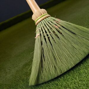 close up shot of a stiff boom brushing the artificial grass