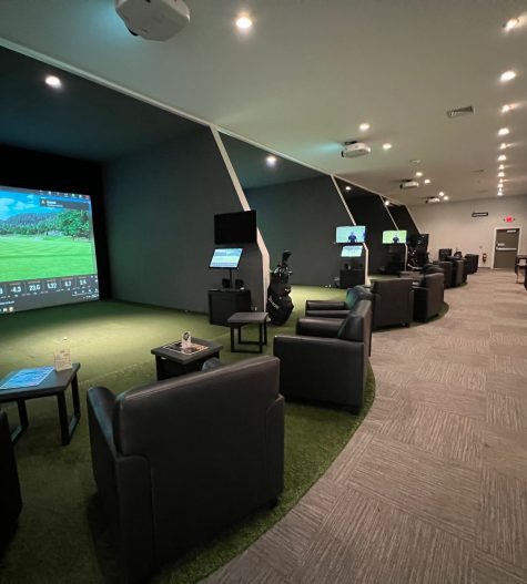 Indoor golf simulator setup showcasing multiple stations